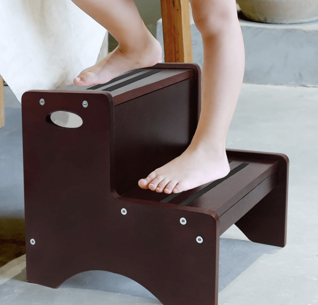 a child's feet on a small step stool